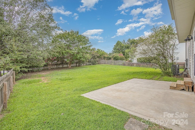 view of yard with central AC and a patio area