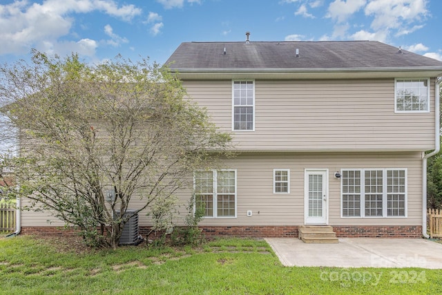 rear view of house featuring a yard and a patio area