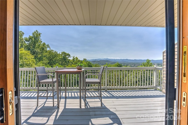 wooden deck with a mountain view