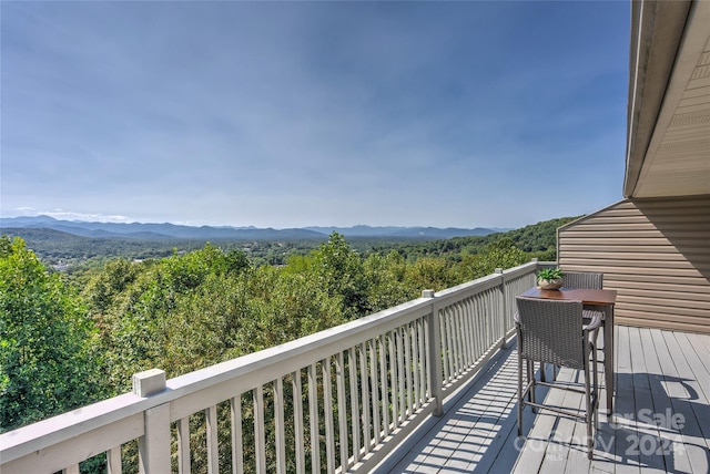 balcony featuring a view of trees and a mountain view