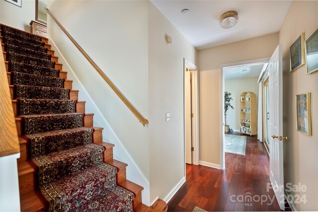 stairway with baseboards and wood-type flooring