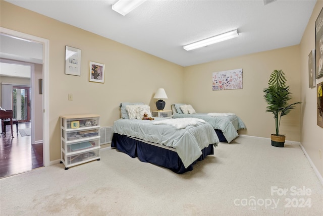 carpeted bedroom with baseboards and visible vents