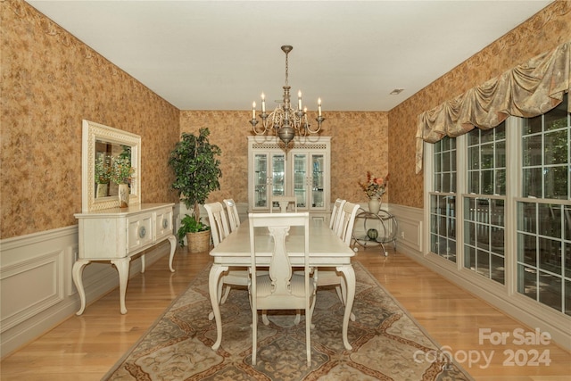 dining area featuring an inviting chandelier and light hardwood / wood-style floors