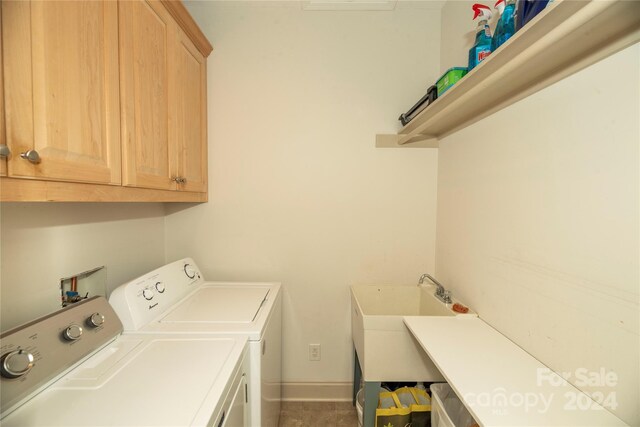 washroom with sink, cabinets, and separate washer and dryer