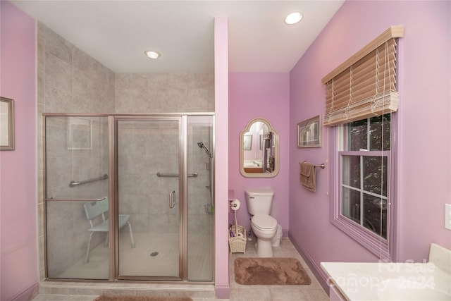 bathroom with toilet, tile patterned floors, vanity, and an enclosed shower