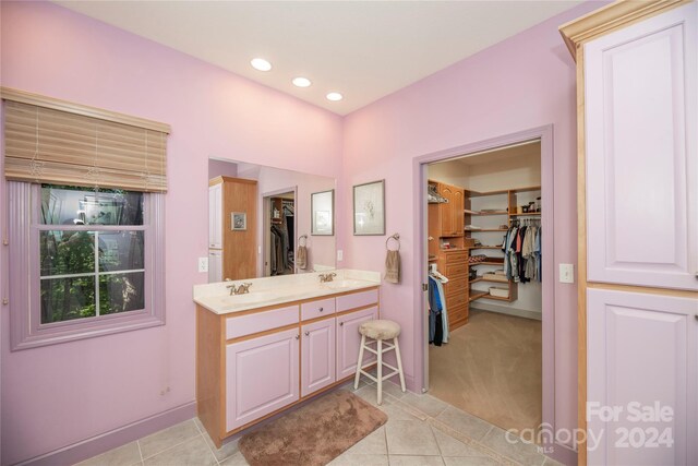 bathroom with double sink vanity and tile patterned flooring