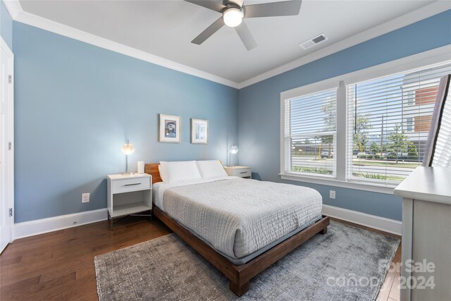 bedroom with ceiling fan, dark hardwood / wood-style flooring, and ornamental molding