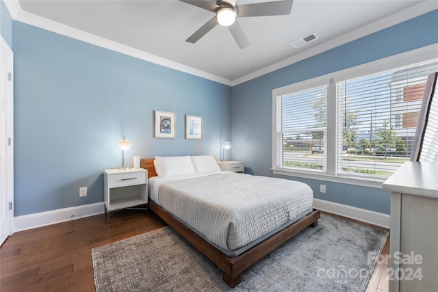 bedroom featuring crown molding, dark hardwood / wood-style floors, and ceiling fan