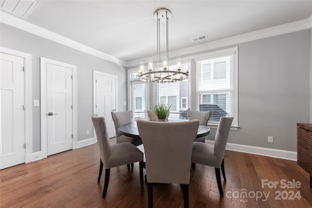 dining room featuring an inviting chandelier, hardwood / wood-style flooring, and ornamental molding