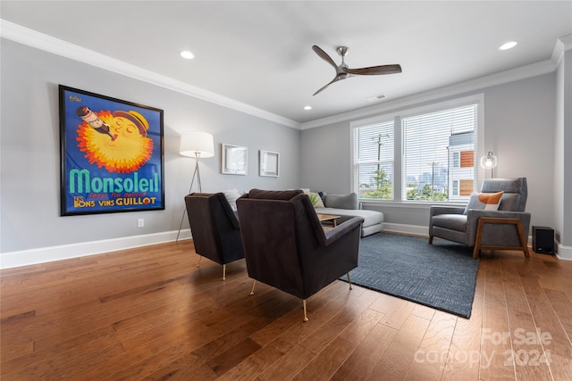 living room with ornamental molding, hardwood / wood-style flooring, and ceiling fan