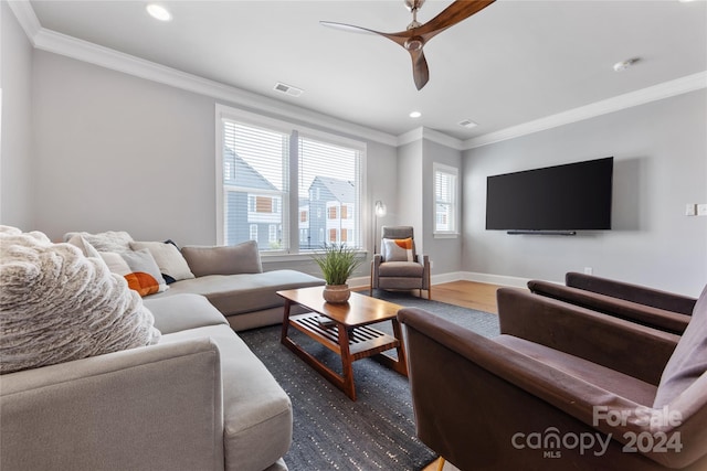 living room with ornamental molding, ceiling fan, and dark hardwood / wood-style floors