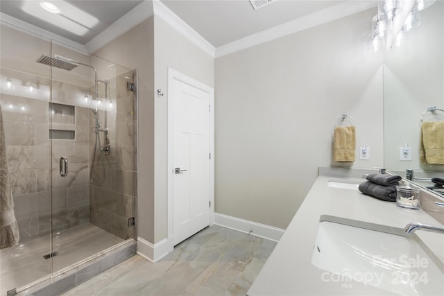 bathroom featuring vanity, a shower with door, and ornamental molding