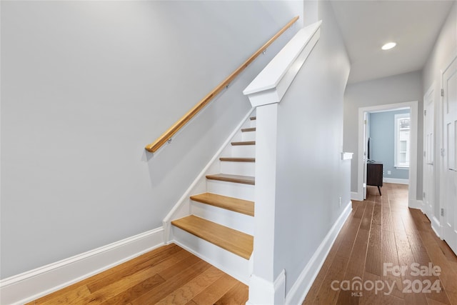 stairway featuring hardwood / wood-style floors