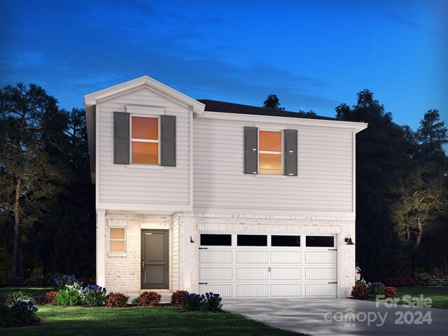 front facade featuring a front yard and a garage