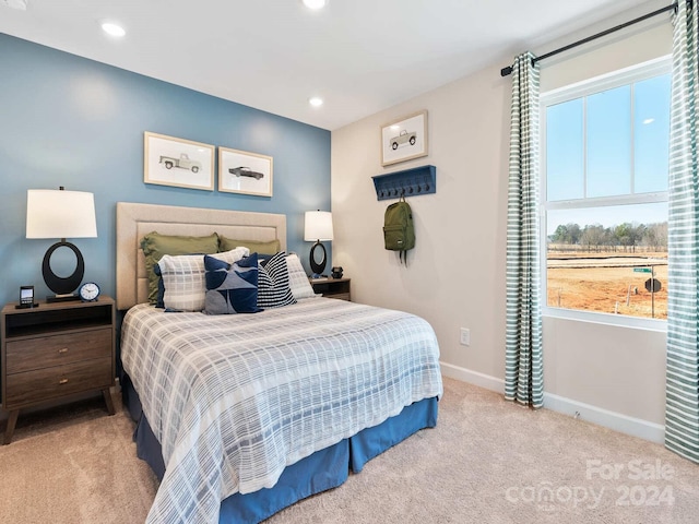 bedroom featuring light carpet, multiple windows, recessed lighting, and baseboards