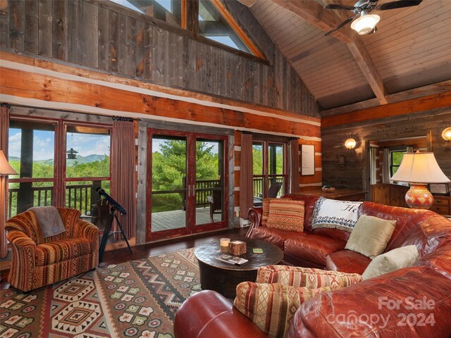 living room featuring french doors, wooden walls, ceiling fan, wooden ceiling, and high vaulted ceiling