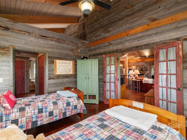 bedroom with vaulted ceiling with beams, french doors, wooden walls, and dark wood-type flooring