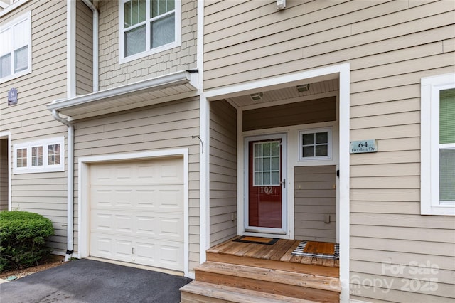 doorway to property with a garage