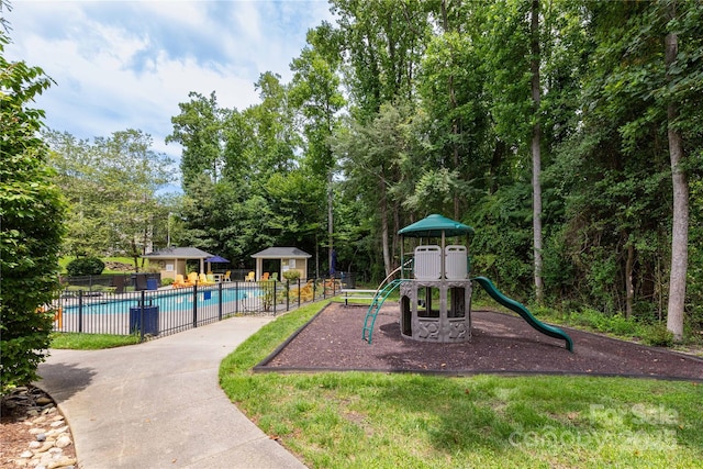 view of jungle gym featuring a community pool