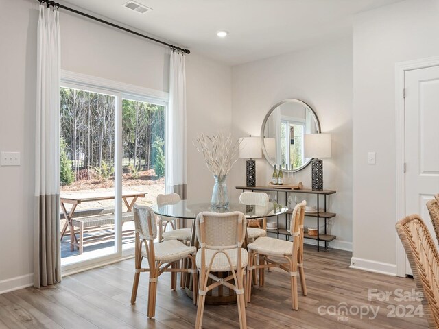 dining space with a wealth of natural light and hardwood / wood-style floors