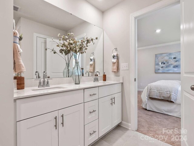 bathroom featuring tile patterned floors, double vanity, and ornamental molding