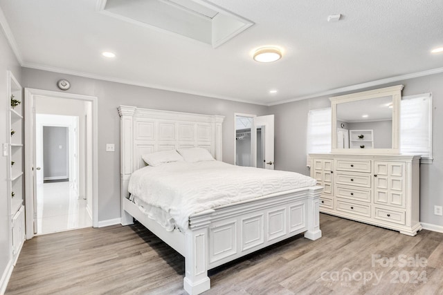 bedroom featuring light hardwood / wood-style flooring and crown molding