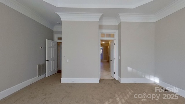 unfurnished bedroom featuring ornamental molding, visible vents, light carpet, and baseboards