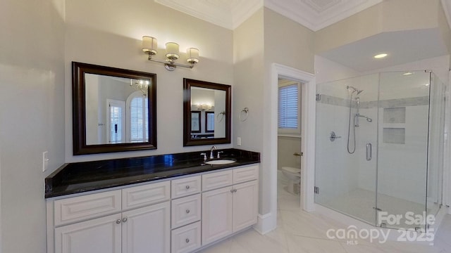 bathroom featuring a shower stall, crown molding, vanity, and toilet