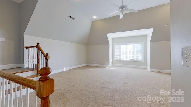 bonus room featuring ceiling fan, light colored carpet, visible vents, baseboards, and vaulted ceiling