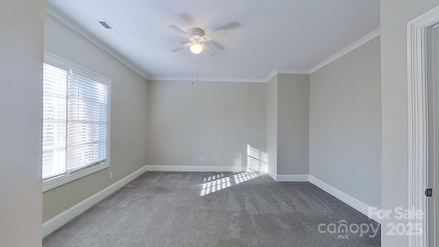 spare room featuring visible vents, baseboards, ceiling fan, crown molding, and carpet flooring