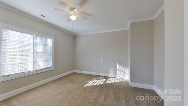 unfurnished room with light colored carpet, visible vents, ornamental molding, a ceiling fan, and baseboards