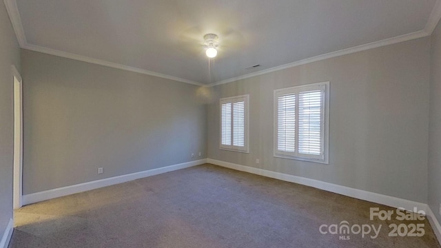 carpeted spare room featuring ornamental molding and baseboards