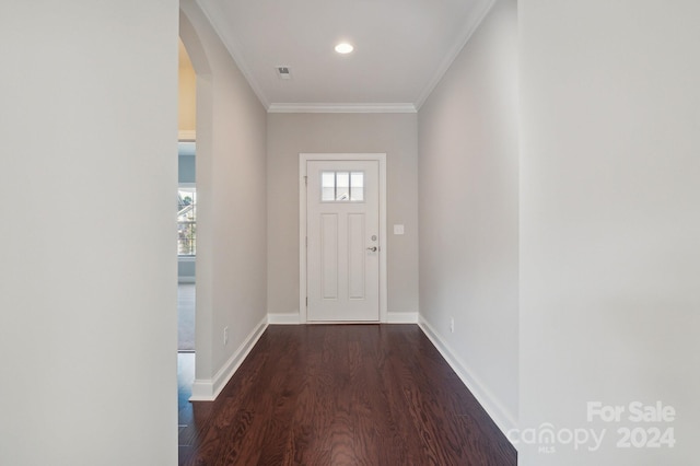 doorway to outside featuring dark hardwood / wood-style floors and crown molding