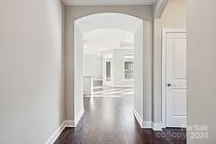 corridor with dark hardwood / wood-style floors