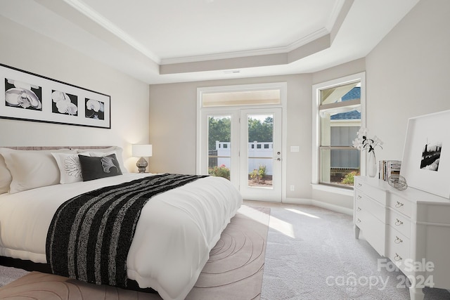 bedroom with ornamental molding, multiple windows, a raised ceiling, and light colored carpet