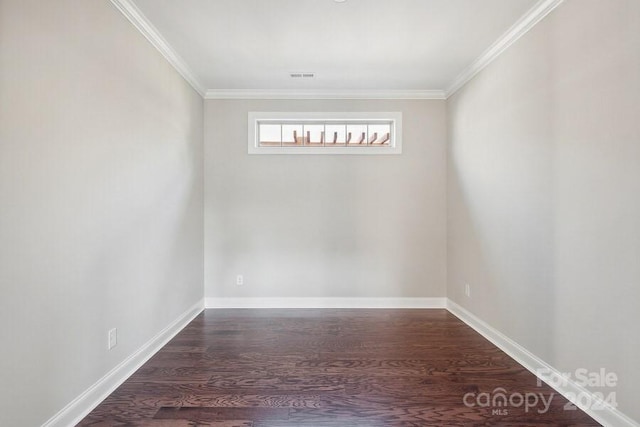 empty room featuring hardwood / wood-style floors and ornamental molding