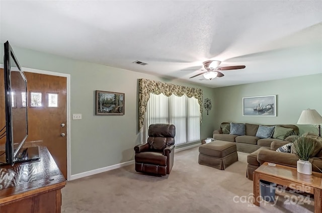 living room featuring light carpet and ceiling fan