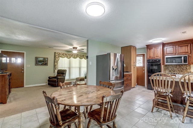 dining space featuring light tile patterned floors, plenty of natural light, and ceiling fan