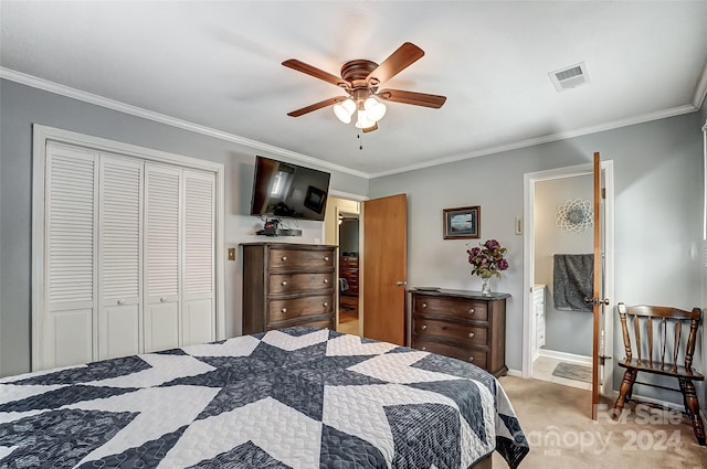 carpeted bedroom featuring ornamental molding, a closet, connected bathroom, and ceiling fan