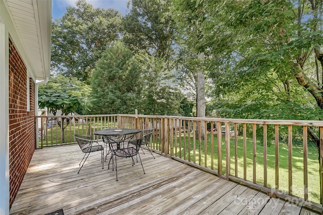 wooden terrace with a lawn