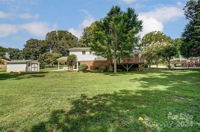 view of yard featuring an outbuilding and a deck