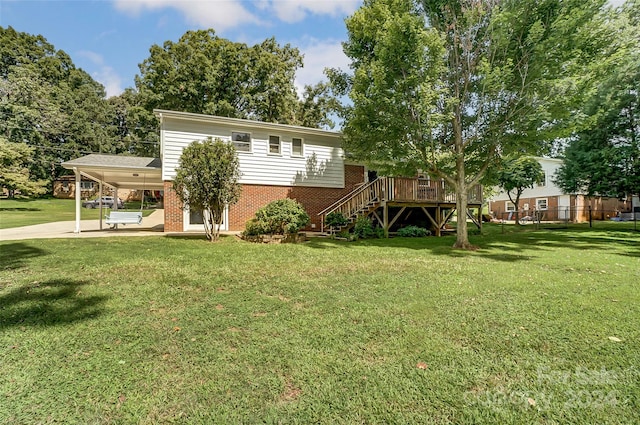 view of front of property featuring a deck, a carport, and a front lawn