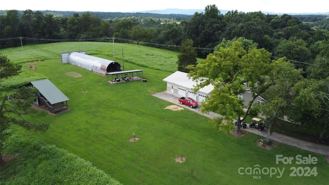 birds eye view of property with a rural view