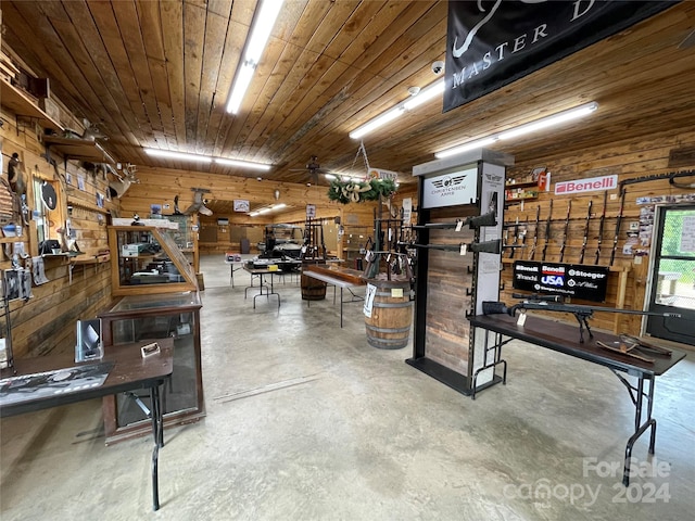 basement featuring ceiling fan, wooden ceiling, and wooden walls