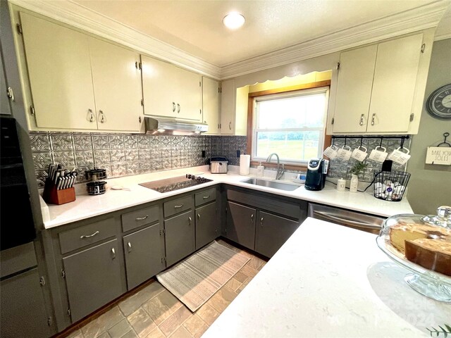 kitchen with backsplash, crown molding, black appliances, sink, and gray cabinets