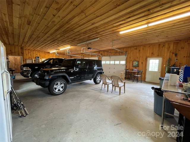 garage featuring wood ceiling and wood walls