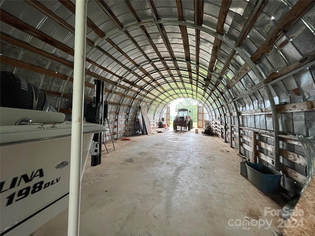 misc room with concrete flooring and vaulted ceiling