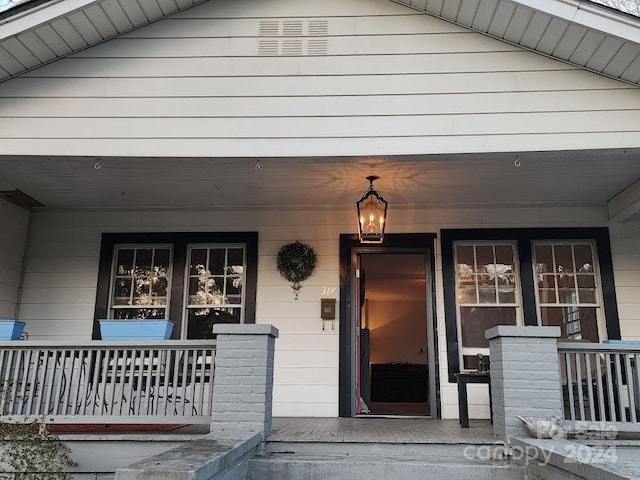 property entrance featuring a porch