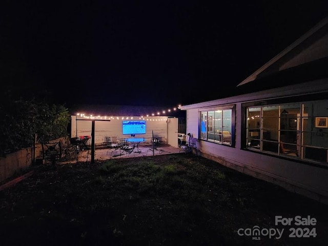 yard at twilight featuring a patio area