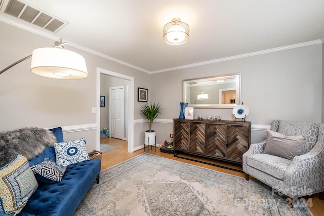 living room featuring hardwood / wood-style flooring and crown molding